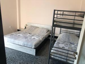 a bedroom with two bunk beds and a ladder at Sea Sunset Appartment in Nea Iraklia