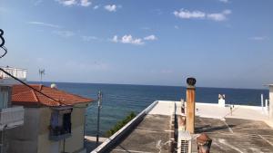 a view of the ocean from the balcony of a house at Sea Sunset Appartment in Nea Iraklia