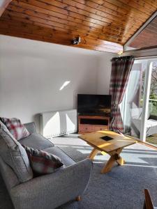 a living room with a couch and a coffee table at Seaview cosy 2 bed home in Lamlash in Lamlash