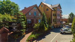 a small town with cars parked in a parking lot at Monika in Krynica Morska