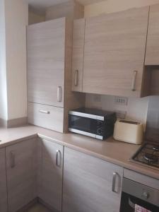a kitchen with a counter top with a microwave at City, Celtic park & Emirates Stadium Apartment, for families or age over 23 in Glasgow