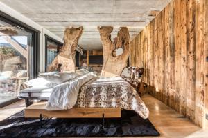 a bedroom with a bed made out of treeunks at Le petit cœur de Megève -Mont770- in Megève