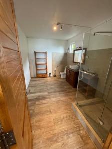 een badkamer met een douche, een toilet en een glazen deur bij Top floor studio -Villa Ibiza in Trou dʼ Eau Douce