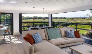 a living room with a couch and a table at Retallack Resort & Spa in Padstow