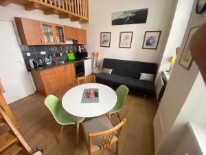 a kitchen and a living room with a table and chairs at Apartmán v Lesní in Jablonec nad Nisou