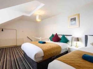 a hotel room with two beds in a room at Luxury 2 Bedroom Home in Leeds