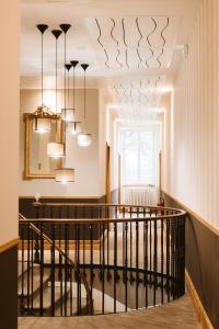 a hallway with a staircase with a chandelier at Domaine d'En Fargou in Saint-Sulpice