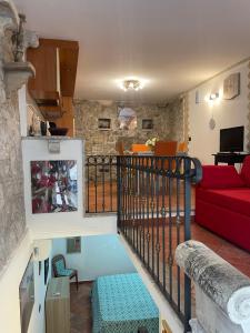 a living room with a red couch and a living room at Majolica Taormina Apartment in Taormina