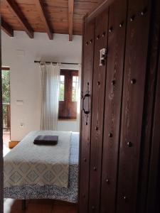 a bedroom with a bed and a wooden wall at Fery & Nico in Granada