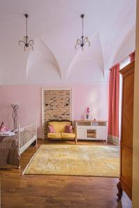 a living room with a bed and a couch at Astronomical Clock Suite by Ruterra in Prague