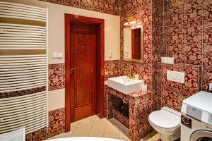 a bathroom with a toilet and a sink at Astronomical Clock Suite by Ruterra in Prague