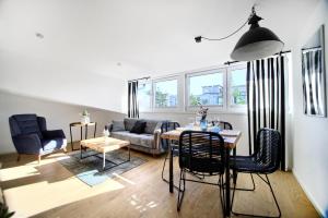 a living room with a table and chairs and a couch at AP Baltic Mielno in Mielno