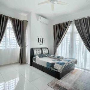 a bedroom with a bed and large windows at RJ Prima (UMT, UniSZA, Spacious, Beach + Netflix) in Kuala Terengganu