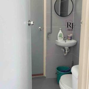 a bathroom with a shower and a toilet and a sink at RJ Prima (UMT, UniSZA, Spacious, Beach + Netflix) in Kuala Terengganu
