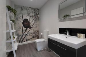 a bathroom with a bird on the wall next to a sink at Minerva House in Pocklington