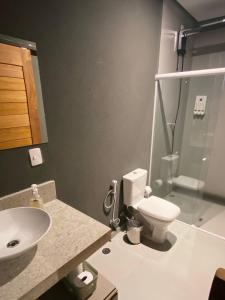 a bathroom with a toilet and a sink and a shower at Kaha Mar - Patacho in Pôrto de Pedras +12 photos