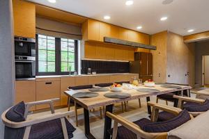 a kitchen with a large wooden table and chairs at Golden Chalet in Bukovel
