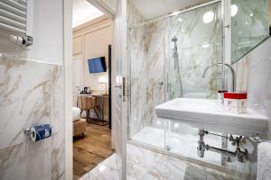 a bathroom with a sink and a shower at Hotel Emma Small Luxury Hotel in Florence