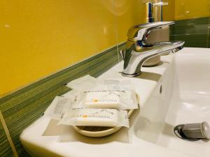 a bathroom sink with toilet paper sitting on it at Villa Marogna in Alghero