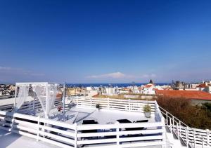 a white balcony with a view of the ocean at Traditional Villa Sofia in Koskinou