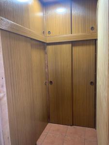 a pair of wooden doors in a room at Cabañas Bosque Sur in Puerto Varas