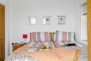 a bedroom with a bed with a tray on it at 3 At The Beach, Torcross in Beesands