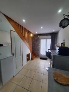 a hallway with an open door and a stairway at La vie là in Saint-Georges-sur-Eure