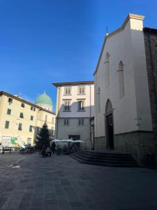 a white building with a church next to some buildings at Da Giulia in Florence