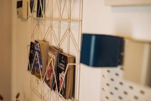 a group of books hanging on a wall at Breathe In in Zambujeira do Mar