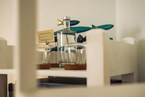 a shelf with a bottle and other items on it at Breathe In in Zambujeira do Mar