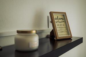 a jar of candle and a picture on a counter at Breathe In in Zambujeira do Mar