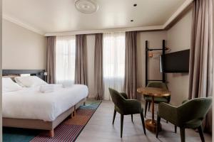 a hotel room with a bed and a table and chairs at Frenchdoor Tours Corneille in Tours +16 photos