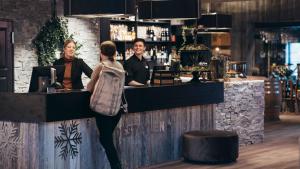 a group of people standing at a bar at Hovdestøylen in Hovden