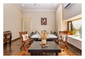 a bedroom with a bed and a table and chairs at Tranquility homestay in Shivpurī