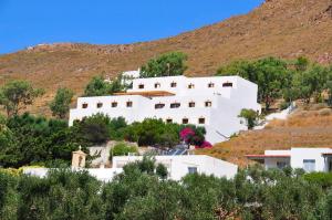 a white house on top of a hill at Golden Sun Hotel Patmos in Patmos