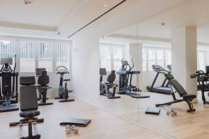 a gym with a lot of exercise equipment and mirrors at Ancient Rome in Rome