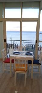 a table and chairs with a view of the ocean at Donna Sicilia 2 in Giardini Naxos