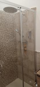 a shower with a glass door in a bathroom at Donna Sicilia 2 in Giardini Naxos