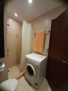 a bathroom with a washing machine and a toilet at Green Life Beach Resort Private Studio Flat First Line Kavatsi Smokinya Beach Sozopol in Sozopol