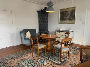 a living room with a wooden table and chairs at Ferienwohnung Adolfshof 1 in Malente