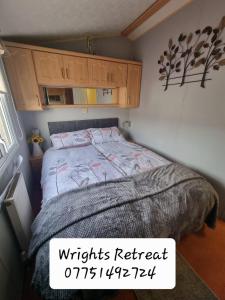 a bedroom with a bed in a small room at Wrights Retreat 4 Lunan View St Cyrus Caravan Park in Saint Cyrus