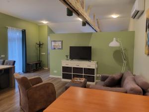 a living room with a couch and a flat screen tv at Appartement - B&B 'la bienvenue' in Venlo, Limburg in Venlo