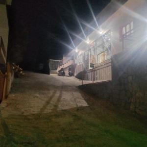 a building at night with the light shining on it at Olive Residency 4BHK Villa with a Parking, Wifi, Campfire, Homemade Food in Kodaikānāl