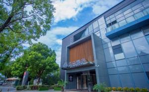 a building with a sign on the side of it at Atour Hotel Suzhou Jinji Lake Ligongdi in Suzhou