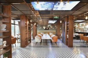 a dining room with a table and chairs at Atour Hotel Chongqing Jiefangbei Raffles City Riverview in Chongqing