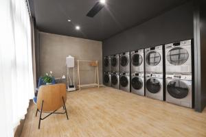 a room with a row of washers and dryers at Atour Hotel Chongqing Jiefangbei Raffles City Riverview in Chongqing