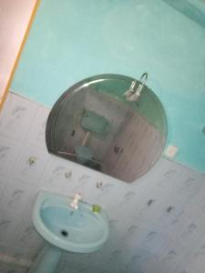 a bathroom with a sink and a mirror at Dinky in Hikkaduwa