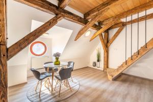 - une salle à manger avec des plafonds en bois, une table et des chaises dans l'établissement Primavera - Castle view apartments, à Prague