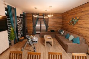 a living room with a couch and a table at CHALET NEBO in Bukovel
