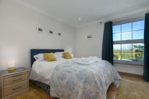 a bedroom with a bed and a window at Sand Dunes 6 The Manor in St Ives